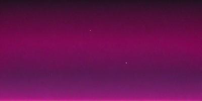 The primary subject of the image is the night sky, which is filled with stars. The setting is a dark, pinkish background that contrasts with the bright stars. The visual style is a combination of a photo and a digital art, creating a unique and captivating atmosphere. The colors and mood of the image are predominantly pink, giving it a warm and serene ambiance.