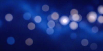 The primary subject of the image is a blue background with a pattern of white dots. The setting appears to be a night sky, with the dots creating a star-like effect. The visual style of the image is a combination of a photo and digital art, as it captures the night sky with a unique pattern. The colors and mood of the image are predominantly blue and dark, creating a serene and peaceful atmosphere.
