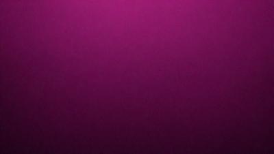 The primary subject of the image is a purple background. The setting is a dark room, and the visual style is a close-up of the purple wall. The colors and mood of the image are predominantly purple, creating a calm and serene atmosphere.