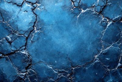 The primary subject of the image is a blue, cracked, and textured surface. The setting is a blue background, and the visual style is a close-up of the blue surface. The colors and mood of the image are predominantly blue, with a slightly rough and cracked appearance.