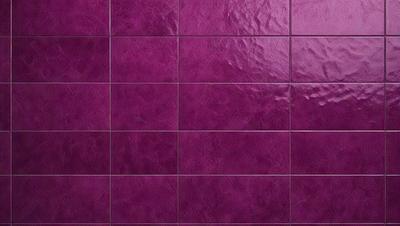 The primary subject of the image is a purple tile wall. The setting is a room with a purple tile wall, which is the main object of the image. The visual style is a close-up of the purple tile wall, showcasing its texture and color. The colors and mood of the image are predominantly purple, creating a calm and soothing atmosphere.