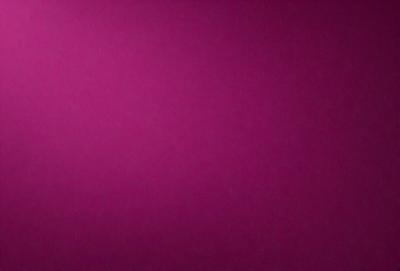 The primary subject of the image is a large, purple wall. The setting is a room with a pink background. The visual style is a close-up of the wall, showcasing its color and texture. The dominant colors are purple and pink, creating a warm and inviting atmosphere.