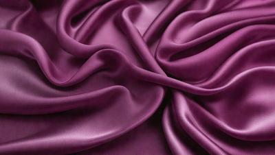 The primary subject of the image is a purple fabric, which is the main object, scene, or focus of the image. The setting or background is a purple fabric, and the visual style is a photo. The colors and mood of the image are predominantly purple, creating a calm and soothing atmosphere.