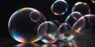 The primary subject of the image is a group of bubbles floating in the air. The setting is a dark background, which contrasts with the bubbles, making them stand out. The visual style is a close-up of the bubbles, showcasing their unique shapes and colors. The colors and mood of the image are predominantly dark, with the bubbles providing a burst of color and light.