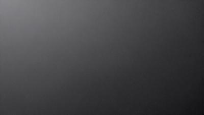 The primary subject of the image is a black background. The setting is a dark, empty space with no visible objects or elements. The visual style is a simple, monochromatic design. The colors and mood are predominantly dark and moody, creating a sense of mystery or drama.