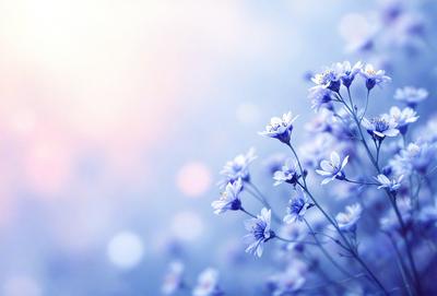 The primary subject of the image is a bouquet of blue flowers, which are the main focus of the scene. The setting is a blue sky, creating a serene and calming atmosphere. The visual style is a close-up of the flowers, showcasing their beauty and details. The colors and mood of the image are predominantly blue, giving it a peaceful and tranquil appearance.