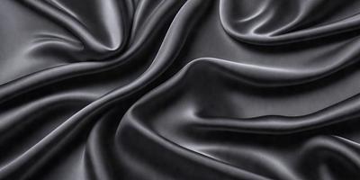 The primary subject of the image is a close-up of a black fabric, possibly a piece of silk or velvet. The setting is a dark background, which emphasizes the fabric's texture and color. The visual style is a close-up, focusing on the details of the fabric. The colors and mood of the image are predominantly dark, with the black fabric being the main focus.