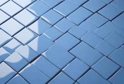 The primary subject of the image is a blue and white tile pattern. The setting is a blue and white tiled surface, which serves as the background. The visual style is a digital art or illustration, as the tiles are depicted in a detailed and intricate manner. The colors and mood of the image are predominantly blue and white, creating a clean and modern atmosphere.