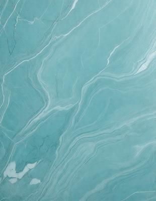 The primary subject of the image is a blue marble wall with a pattern of swirls and waves. The setting is a room with a blue marble floor, which complements the blue marble wall. The visual style is a close-up of the marble wall, showcasing its intricate pattern. The colors and mood of the image are predominantly blue, creating a serene and calming atmosphere.