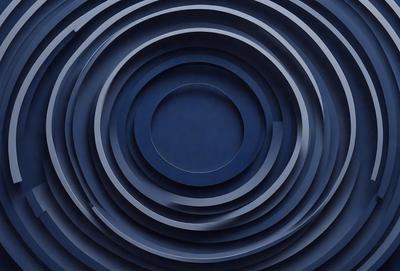 The primary subject of the image is a blue circle, which is the main object, scene, or focus of the image. The setting/background features a dark blue surface, which adds to the overall atmosphere of the image. The visual style of the image is a photo, as it captures a real-life scene. The colors and mood of the image are predominantly dark blue, creating a moody and dramatic atmosphere.