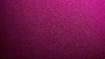 The primary subject of the image is a close-up of a purple leather surface. The setting is a dark room, and the visual style is a photo. The dominant colors are purple and pink, creating a moody and dramatic atmosphere.