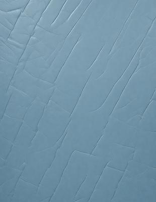 The primary subject of the image is a blue surface with a pattern of wrinkles and creases. The setting is a room with a blue wall, and the visual style is a close-up of the blue surface. The colors and mood of the image are predominantly blue, creating a calm and serene atmosphere.