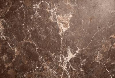 The image features a marble wall with a brown and white color scheme. The wall is covered in a pattern of brown and white spots, giving it a unique and textured appearance. The setting appears to be a room with a brown floor, which complements the marble wall. The visual style of the image is a close-up of the marble wall, showcasing its intricate pattern and texture. The colors and mood of the image are warm and earthy, creating a sense of natural beauty and elegance.