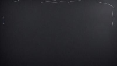 The primary subject of the image is a black background with white writing. The setting is a black surface, and the visual style appears to be a combination of a photo and digital art. The colors are predominantly black and white, creating a stark and minimalist atmosphere.