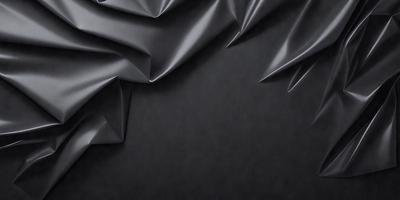 The primary subject of the image is a close-up of a gray fabric, possibly a piece of clothing or a curtain. The setting is a black background, which contrasts with the gray fabric. The visual style appears to be a photo, as the fabric is captured in detail. The colors and mood of the image are predominantly dark, with the gray fabric being the main focus.