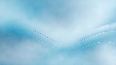 The primary subject of the image is a blue sky with a few white clouds. The setting is a cloudy day, and the visual style is a painting or drawing. The colors and mood of the image are predominantly blue and calm, creating a serene atmosphere.