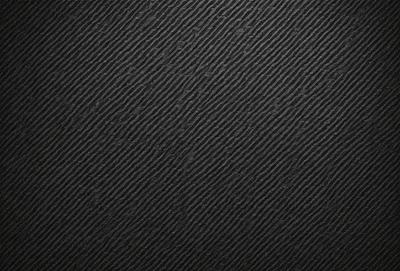 The primary subject of the image is a black background with a pattern of small, white, and black dots. The setting is a dark room, and the visual style is a close-up of the pattern. The colors and mood of the image are predominantly dark and moody, with the black background and the white and black dots creating a striking contrast.