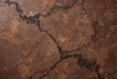 The primary subject of the image is a brown marble tile with a pattern of cracks and holes. The setting is a room with a brown marble floor, which complements the brown marble tile. The visual style is a close-up of the marble tile, showcasing its unique texture and pattern. The colors and mood of the image are warm and earthy, with the brown marble tiles and floor creating a natural and elegant atmosphere.