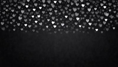 The primary subject of the image is a pattern of hearts. The hearts are scattered across the background, creating a visually appealing and heartwarming scene. The setting appears to be a dark background, which contrasts with the bright hearts, making them stand out even more. The visual style of the image is a combination of digital art and illustration, as the hearts are carefully arranged and the overall composition is well-executed. The colors and mood of the image are predominantly warm and inviting, with the hearts symbol