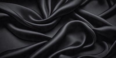 The primary subject of the image is a close-up of a black fabric, possibly a piece of silk or velvet. The setting is a dark background, which emphasizes the fabric's texture and color. The visual style is a close-up, which highlights the fabric's details. The colors and mood of the image are predominantly dark, with the black fabric being the main focus.
