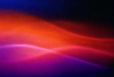 The primary subject of the image is a colorful, swirling pattern that resembles a wave. The setting is a purple background, which adds to the overall visual style. The colors and mood of the image are vibrant and energetic, creating a lively and dynamic atmosphere.
