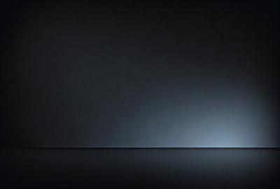 The primary subject of the image is a black background with a white line. The setting is a dark room, and the visual style is a simple, minimalist design. The colors and mood are predominantly dark and moody, with the white line providing a contrasting element.