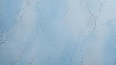 The primary subject of the image is a blue sky with white clouds. The setting is a cloudy sky, and the visual style is a photo. The colors and mood of the image are predominantly blue and calm, creating a serene atmosphere.