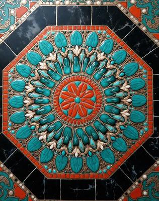 The primary subject of the image is a decorative tile with a blue and green design. The tile features a circular pattern with a centerpiece that resembles a flower. The setting is a wall, and the visual style appears to be a combination of digital art and illustration. The dominant colors in the image are blue and green, creating a calm and soothing atmosphere.