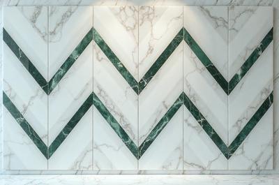 The primary subject of the image is a large, white marble wall with a pattern of green and white diamond shapes. The setting is a room with a white marble floor, and the visual style is a photo. The colors and mood of the image are predominantly white and green, creating a clean and elegant atmosphere.
