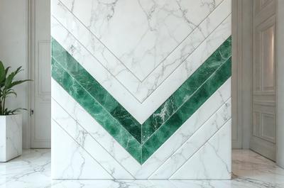 The primary subject of the image is a white marble wall with a green and white pattern. The setting is a room with a white marble countertop. The visual style is a photo of the marble wall. The colors and mood of the image are predominantly white and green, creating a clean and fresh atmosphere.