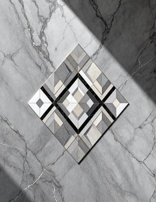 The primary subject of the image is a square tile with a geometric pattern, likely made of marble. The tile is placed on a marble surface, which serves as the setting and background of the image. The visual style of the image is a close-up of the tile, showcasing its intricate design and texture. The dominant colors in the image are shades of gray, which contribute to a sophisticated and elegant atmosphere.