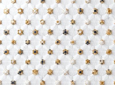 The primary subject of the image is a pattern of gold stars on a white background. The setting appears to be a wall or a surface with a marble texture. The visual style is a combination of digital art and illustration, creating a unique and eye-catching design. The colors and mood of the image are predominantly white and gold, giving it a warm and elegant appearance.