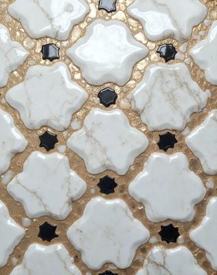 The primary subject of the image is a marble tile with a gold design. The setting is a wall, and the visual style is a close-up of the tile. The colors and mood of the image are predominantly gold and white, giving it a luxurious and elegant appearance.