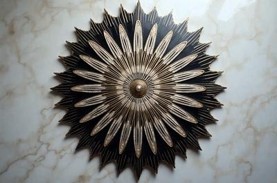 The primary subject of the image is a decorative piece featuring a gold sun design. The setting is a white marble wall, which serves as the backdrop for the artwork. The visual style appears to be a combination of digital art and illustration, creating a unique and eye-catching design. The colors and mood of the image are predominantly gold and warm, giving the piece a luxurious and inviting appearance.
