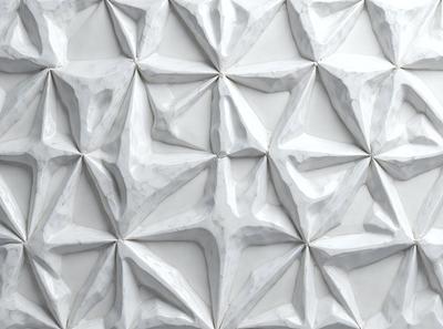 The image features a white marble wall with a pattern of white and gray diamond shapes. The wall appears to be made of marble, giving it a luxurious and elegant appearance. The diamond shapes are arranged in a way that creates a visually appealing and intricate design. The overall atmosphere of the image is clean, sophisticated, and elegant.