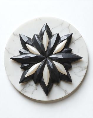 The primary subject of the image is a black and white flower design, which is the main object, scene, or focus of the image. The setting is a white marble surface, which serves as the backdrop for the flower design. The visual style of the image is a combination of photo and digital art, as it appears to be a close-up of the flower design on a marble surface. The dominant colors in the image are black and white, giving it a classic and elegant appearance.