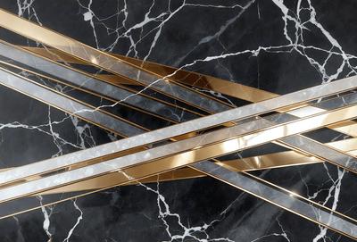 The primary subject of the image is a decorative piece made of metal, which is placed on a marble surface. The setting is a black and white marble countertop, and the visual style is a close-up of the metal piece. The colors and mood of the image are predominantly black and white, giving it a classic and elegant appearance.
