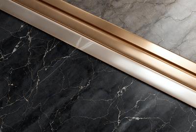 The primary subject of the image is a pair of gold and silver metal bars, which are placed on a marble countertop. The setting is a modern and elegant environment, with the marble countertop serving as the backdrop. The visual style of the image is a close-up of the metal bars, showcasing their intricate design and texture. The colors and mood of the image are predominantly neutral, with the gold and silver tones of the metal bars contrasting against the marble countertop.