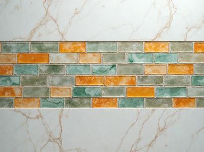 The primary subject of the image is a marble tile wall with a green and orange pattern. The setting is a bathroom, and the visual style is a photo. The dominant colors are green and orange, creating a warm and inviting atmosphere.
