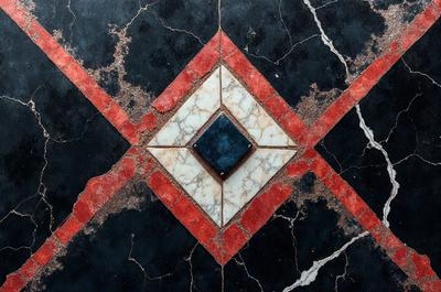 The primary subject of the image is a blue square tile with a red triangle on top of it. The setting is a black and white marble floor, which adds a contrasting element to the scene. The visual style is a close-up of the tile, showcasing its intricate design. The colors and mood of the image are predominantly black and white, giving it a classic and elegant appearance.