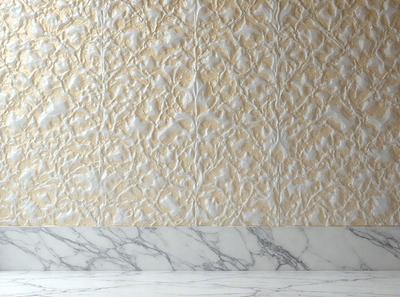 The primary subject of the image is a wall with a patterned design. The setting is a room with a marble countertop. The visual style is a combination of a photo and a patterned design. The dominant colors are gold and white, creating a warm and elegant atmosphere.