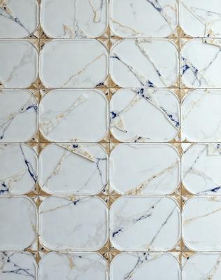 The primary subject of the image is a white tile wall with a marble pattern. The setting is a bathroom, and the visual style is a photo. The dominant colors are white and blue, creating a clean and soothing atmosphere.