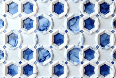 The primary subject of the image is a pattern of blue and white tiles. The setting is a white marble wall, which serves as the background. The visual style is a close-up of the tiles, showcasing their intricate design. The colors and mood of the image are predominantly blue and white, creating a clean and elegant atmosphere.