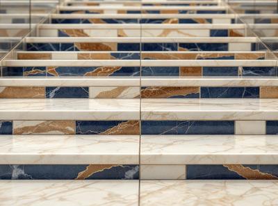The primary subject of the image is a set of marble stairs with a blue and gold pattern. The stairs are made of marble and have a blue and gold pattern on them. The setting is a staircase, and the visual style is a photo. The colors and mood of the image are predominantly blue and gold, giving the stairs a luxurious and elegant appearance.