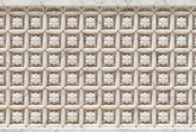 The primary subject of the image is a white marble wall with a pattern of flower designs. The setting is a white marble wall, and the visual style is a close-up of the marble wall. The colors and mood of the image are predominantly white, giving it a clean and elegant appearance.