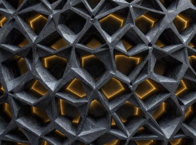 The primary subject of the image is a close-up of a patterned surface, which appears to be a stone or marble wall. The setting is indoors, with the wall being the main focus of the scene. The visual style is a combination of a photo and digital art, as the pattern is intricate and the colors are vibrant. The dominant colors are yellow and orange, creating a warm and inviting atmosphere.
