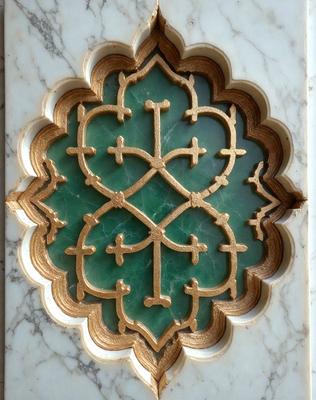 The primary subject of the image is a green and gold decorative design, possibly a religious symbol or a piece of art. The setting is a marble surface, which adds to the elegance and sophistication of the design. The visual style appears to be a combination of photo and digital art, creating a unique and intricate pattern. The colors and mood of the image are predominantly green and gold, evoking a sense of spirituality and richness.