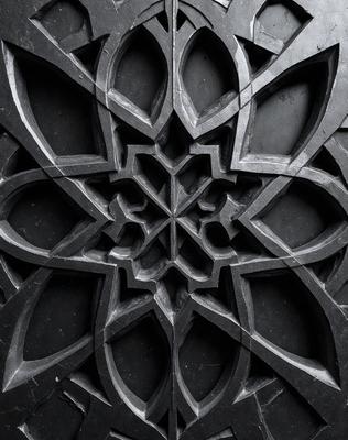 The primary subject of the image is a black and white design featuring a cross-like pattern. The setting is a black background, which contrasts with the intricate design. The visual style is a combination of a photo and a digital art, illustration, or drawing. The colors and mood of the image are predominantly dark and moody, with the black and white design adding a sense of depth and complexity to the overall atmosphere.