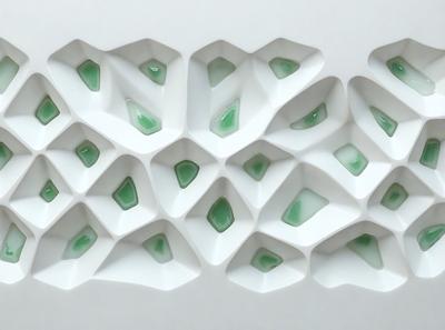 The primary subject of the image is a white wall with a pattern of green glass squares. The setting is a white wall, and the visual style is a pattern of green glass squares. The colors and mood of the image are predominantly white and green, creating a clean and fresh atmosphere.