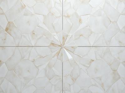 The primary subject of the image is a white marble wall with a pattern of hexagons. The setting is a room with a white marble floor. The visual style is a close-up of the marble wall, showcasing the intricate pattern. The colors and mood of the image are predominantly white, giving it a clean and elegant appearance.